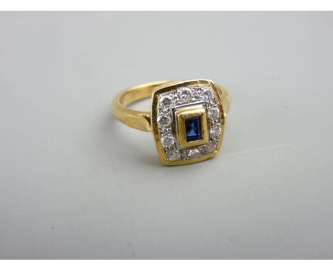 AN 18CT GOLD DIAMOND &amp; SAPPHIRE DRESS RING having a small oblong cut centre sapphire with ten surrounding small diamonds,