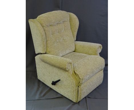 A LIGHT FLORAL UPHOLSTERED AND RECLINING EASY CHAIR