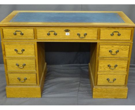 A MODERN LIGHT WOOD VENEERED TWIN PEDESTAL BLUE TOOL TOP DESK