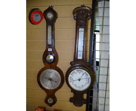 A GEORGIAN BANJO BAROMETER (for restoration) and a Victorian carved oak barometer with thermometer 