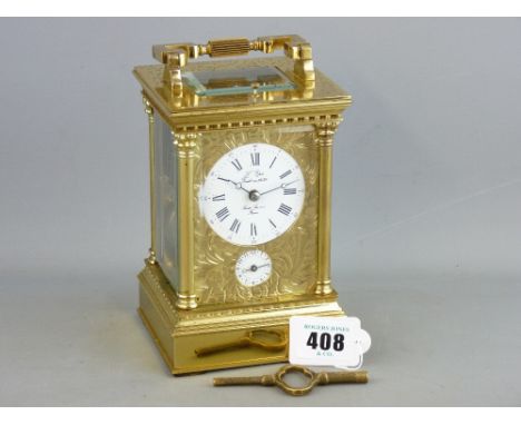 A FRENCH BRASS REPEATING CARRIAGE CLOCK, chase decorated front and white dial set with Roman numerals, lower alarm dial, the 