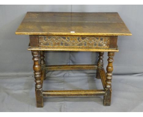 AN 18TH CENTURY OAK SIDE TABLE with an overhanging top to a narrow drawer with carved and scrolled front panel over an open b