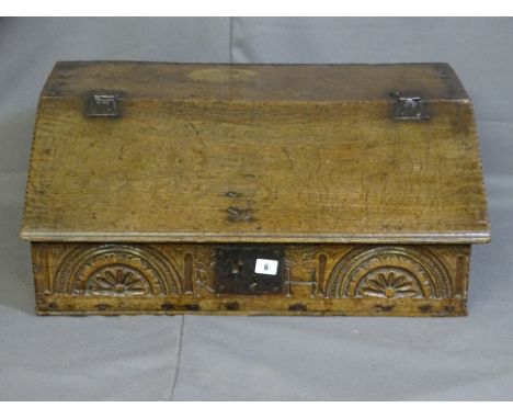 AN OAK BIBLE BOX, late 18th/early 19th century with iron hinges to the slope and a carved lunette panel to the front with iro