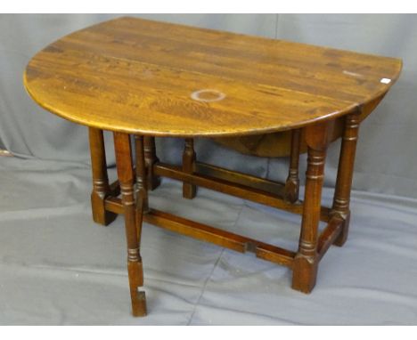 AN OAK CIRCULAR TWIN FLAP GATE LEG DINING TABLE