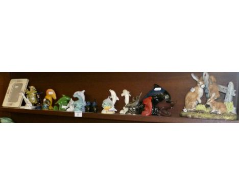 Shelf of assorted Dolphin ornaments and others