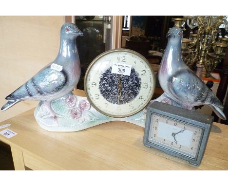 Kitsch lustre china mantle clock, the movement being flanked by two pigeons and another small Art Deco metal cased clock by E