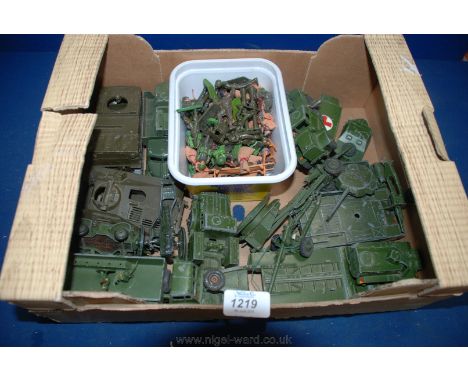 A quantity of Army vehicles including lorries, jeeps, guns, Landrovers and a quantity of plastic Army men and sacks of corn, 