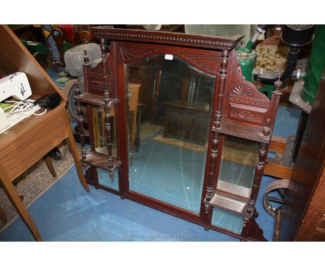 An Edwardian Mahogany Overmantle Mirror, having moulded cornice with dentil moulding, large arched top central bevel plate mi