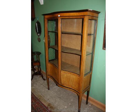 An Edwardian light Mahogany serpentine fronted china Display Cabinet having moulded top over the pair of opposing single uppe