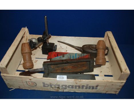 A crate of tools including two oil stones, oil can, spokeshave and a large set of dividers and pressure gauge.
