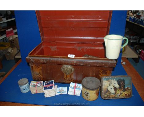 A metal Trunk with wood-grain effect paint finish and brass lock, 21" long x 12" x 11 1/4" and quantity of old toffee and cig