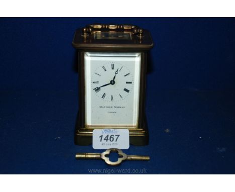 A Brass Carriage Clock by Matthew Norman of London, with brass handle to the top over bevel edge top pane, glazed all round, 