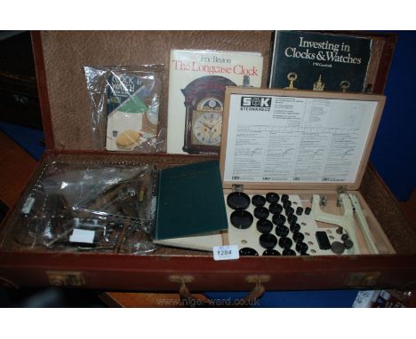 A brown hard Case containing watch Tools and watch books.