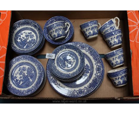 A large quantity of English Ironstone tableware, comprising dinner plates, side plates, cups and saucers and pudding bowls, i