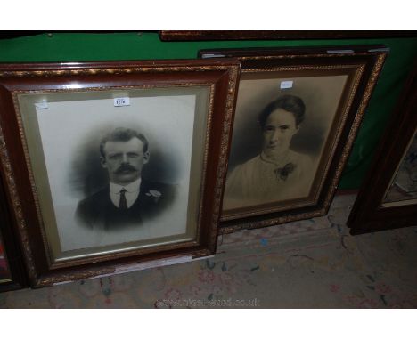 Two old black and white portrait Photographs, one gentleman and one lady, framed.