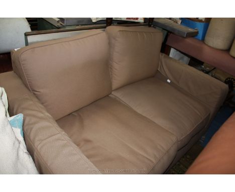 A modern square form two seater Sofa on light brown canvas look fabric upholstery.