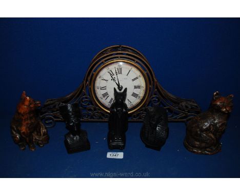 A modern metal bracket Clock, three Egyptian figures, and two cat figures.