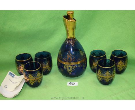 A blue glass Decanter and set of six Glasses, gilt decorated, and marked 'Venezia 2002', 'Thomas'.