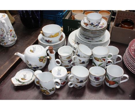 A quantity of Royal Worcester 'Evesham' china including dinner plates, cereal bowls, teapot, sugar bowl and lid, cups and sau