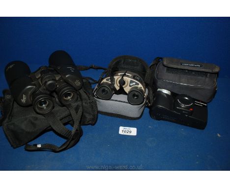 A pair of Sunagor Binoculars and an Olympus camera.