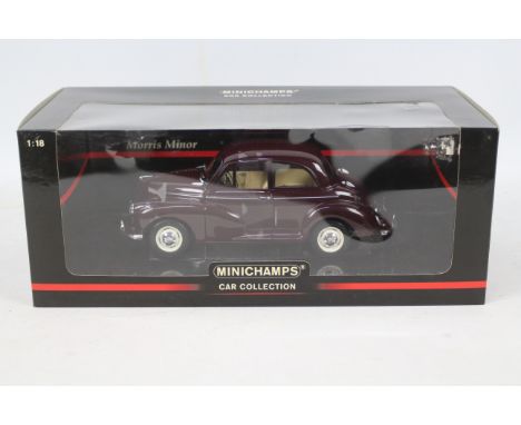 Minichamps - A boxed 1:18 scale Morris Minor 1000 in maroon # 137002. The car appears Mint in a Good box with some creasing t