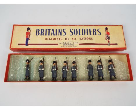 Britains - A boxed set of 8 x Grenadier Guards in Winter Overcoats # 312. The figures appear in Good overall condition with l