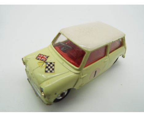 Corgi - a diecast model Morris Mini-Cooper competition model, primrose yellow body, white roof, red interior, flags to the bo