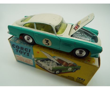 Corgi - a diecast model Aston Martin competition model, green and white body, yellow interior, flags to the bonnet which open