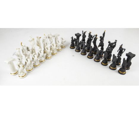 A Franklin Mint black and white porcelain "Chess Set of The Gods", with gilt highlights, height of king 14cm. CONDITION REPOR