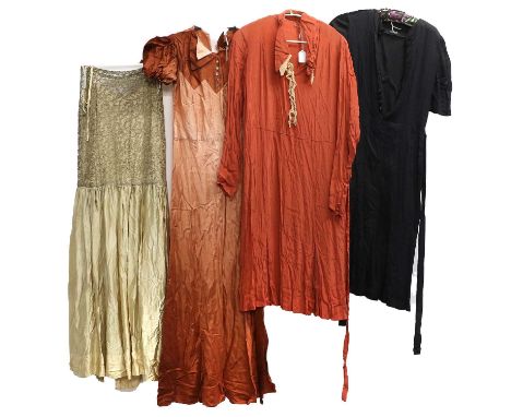 Four Circa 1920s Dresses, comprising a navy example with short sleeves, buttons to the bodice and an attached fabric tie at t