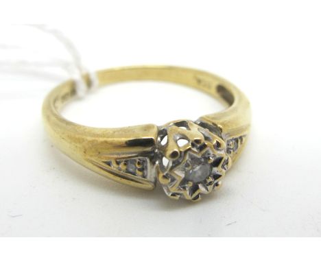 A Modern 9ct Gold Single Stone Diamond Ring, the brilliant cut stone illusion set, between inset shoulders, stamped  ".10" "D