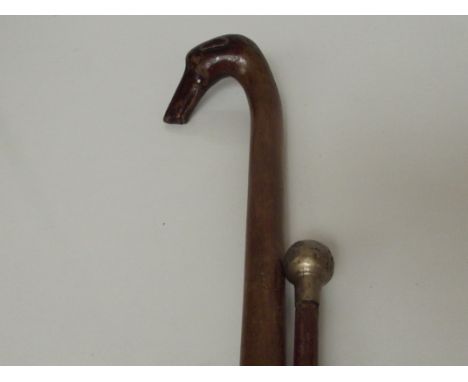 Walking stick in the form of a greyhound together with a swagger stick 