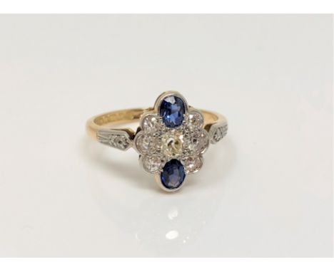 A vintage 18ct gold and platinum sapphire and diamond cluster ring, size M CONDITION REPORT: 2.7g. Hallmarked Birmingham 1950