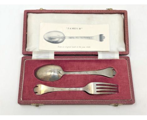 A cased James I style silver fork and spoon