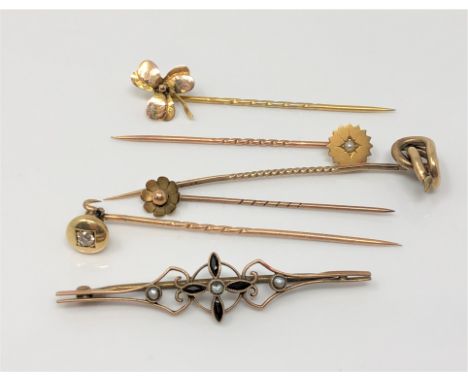A group of gold stick pins and a brooch including one diamond set example CONDITION REPORT: 8.2g gross