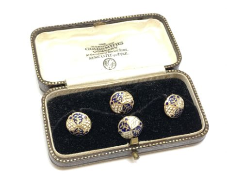 A set of 4 gold white and black enamel studs, 4.25g.