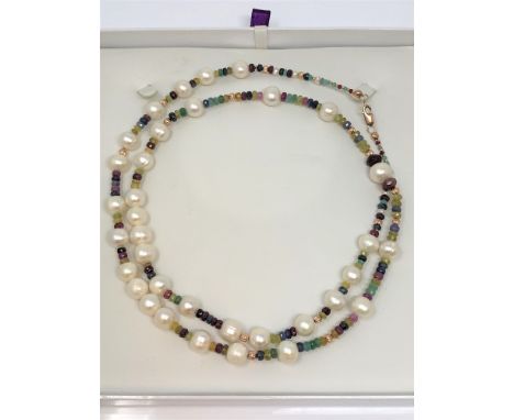 A cultured pearl necklace with 9ct rose gold clasp, strung with emerald, ruby and sapphire beads