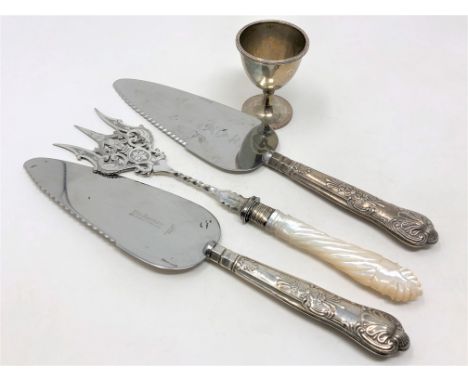 A Victorian silver egg cup and three items of silver mounted cutlery including toasting fork