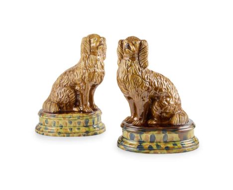  PAIR OF LARGE SCOTTISH FIFE POTTERY FIREPLACE SPANIELS EARLY 19TH CENTURY modelled seated with pale brown glaze, on an oval 