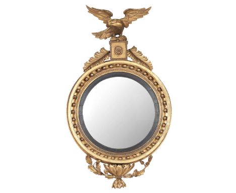  REGENCY GILTWOOD CONVEX MIRROR EARLY 19TH CENTURY the circular mirror plate in an ebonised reeded slip and moulded frame wit
