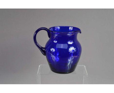 A good antique 19th Century hand-blown 'Bristol Blue' glass jug, of helmet shape, excellent rich cobalt colour, polished pont