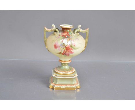 A Royal Worcester twin handled pedestal urn shape blush ivory vase, painted with parrot tulip flowers. Green printed mark to 