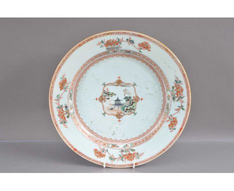 An 18th Century Chinese Kangxi Period famille verte plate or charger, the central cartouche decorated with a scene of a lake 