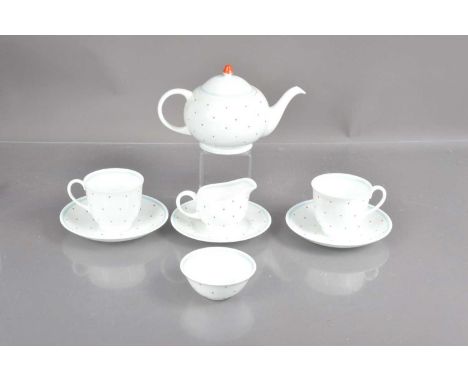 A Susie Cooper polkadot pattern bone china two-person teaset, consisting of a teapot, two cups and saucers, a milk jug and pl