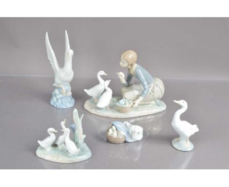 A good group of five Lladro and Nao duck, goose and geese figurines, including a girl feeding ducks, a basket with duck and d