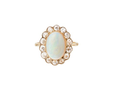 claw set with an oval opal cabochon, in a single border of old round-cut diamonds, to a plain shank stamped 18ct(Ring size: N
