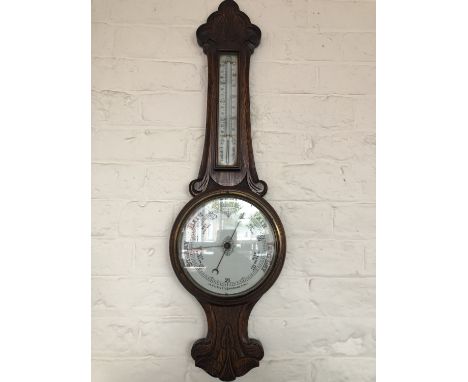 A late 19th / early 20th Century carved oak banjo barometer, 85 cm