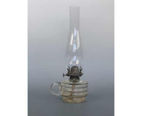 An antique glass finger oil lamp
