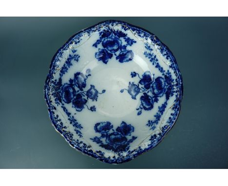 A Victorian blue-and-white transfer-printed wash basin, decorated with sprays of poppies and foliate garlands, gilt-enriched,