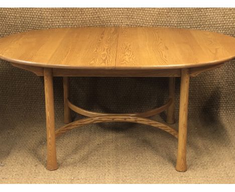 An Ercol elm extendable dining table and six chairs, table 162 x 108 cm (when closed)